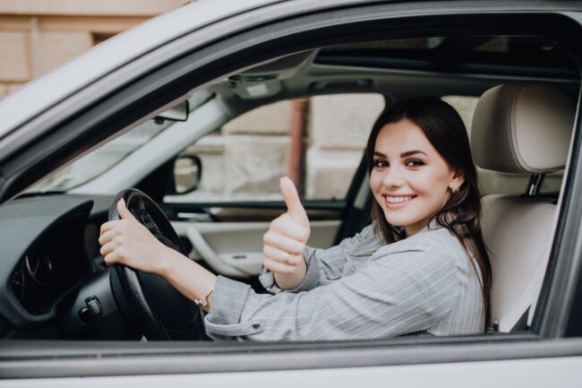beautiful-young-latin-woman-driving-her-brand-new-car-and-showing-her-thumb-up (1)